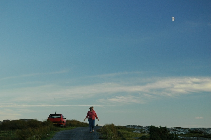 Diane Harrington and the first quarter moon, near Clifden, Ireland